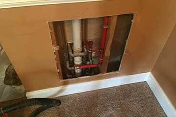 Rerouting pipes to fix slab leak.
